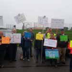 group of people holding signs